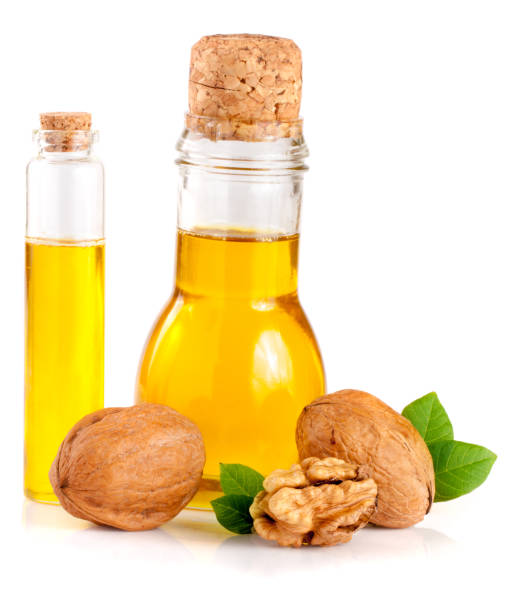 istock Walnut oil with nuts isolated on a white background 824991850