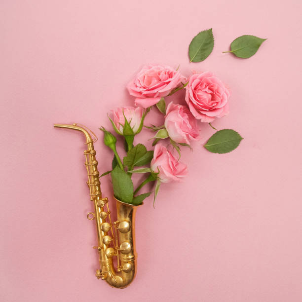 istock Jazz Day. Saxophone with flowers. Flat lay, top view 824994498