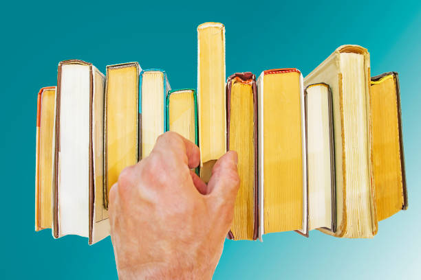 istock hand of man takes book from shelf isolated 824998334