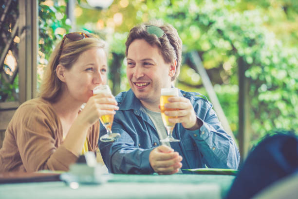 istock Couple drinking beer outdoors 824999116