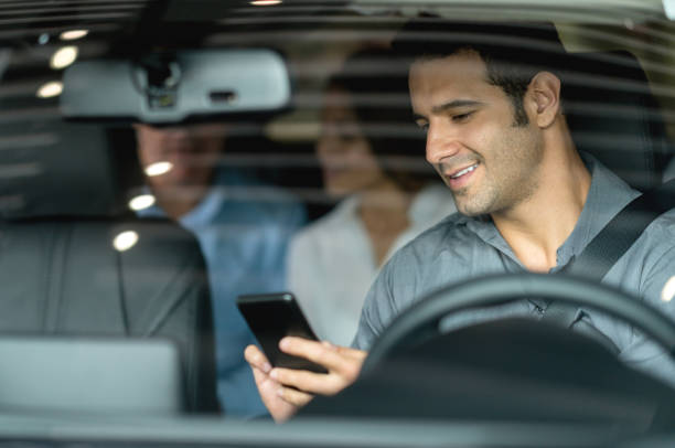 istock Crowdsource taxi driver showing destinations on his cell phone 825001530