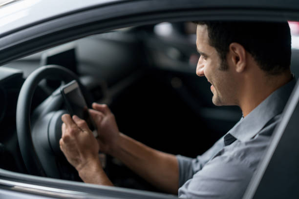 istock Crowdsource taxi driver looking at his cell phone 825001550