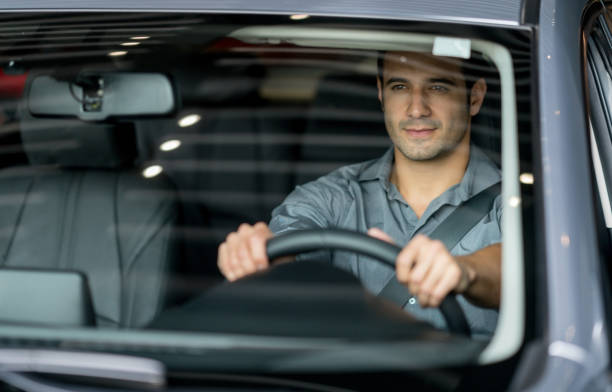 istock Happy man at a car dealership going for a test drive 825001720