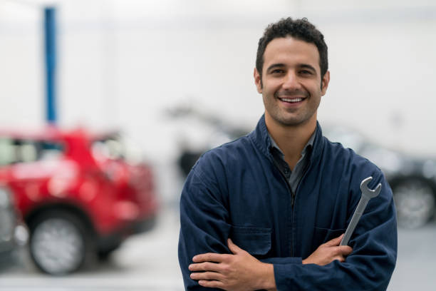 istock Happy mechanic working at an auto repair shop 825001722