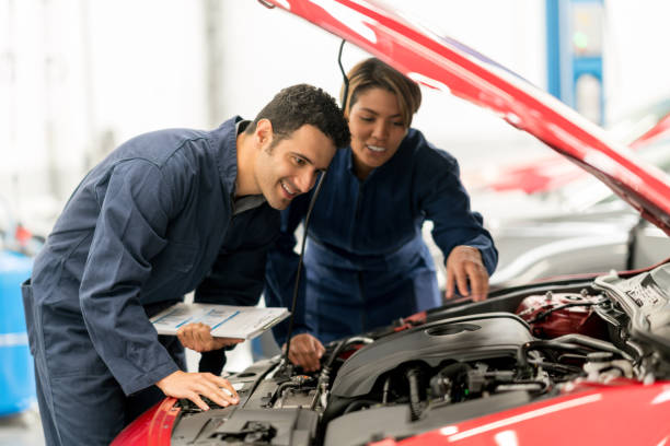 istock Mechanics fixing a car at a garage 825001840