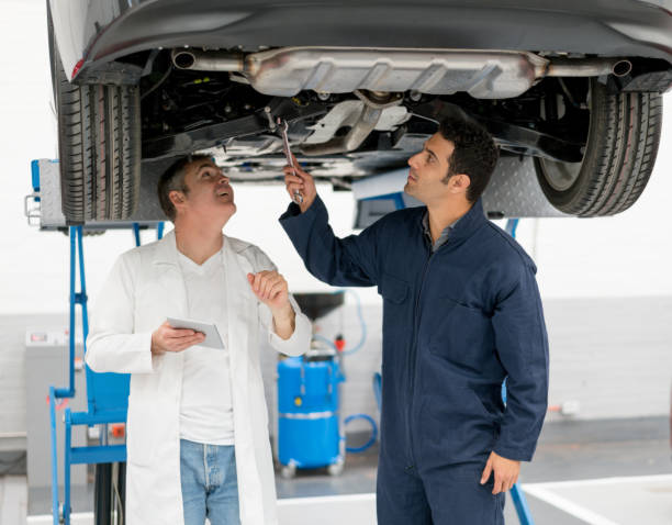 istock Mechanics looking underneath a car at an auto repair shop 825001846