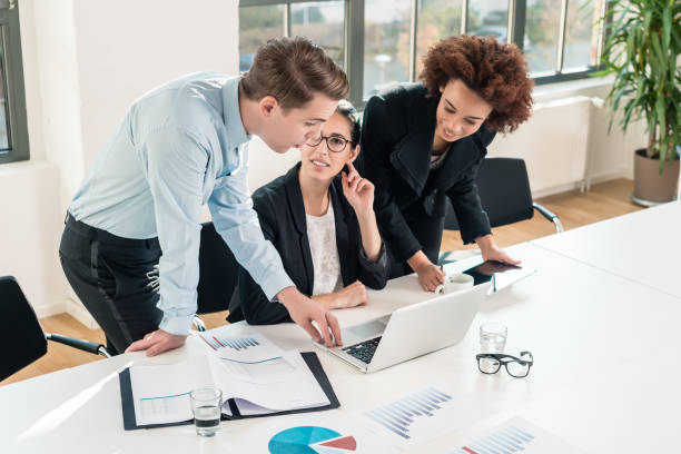 istock Three members of a young professional team working together 825002446