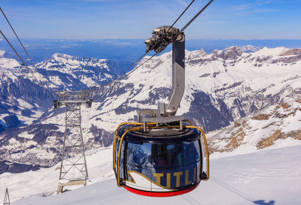 Rotair overhead cable car on Mt. Titlis in Switzerland Mt. Titlis, Switzerland - 9 March, 2016: a gondola of the Rotair overhead cable car. Rotair gondolas make a 360 degrees turn during their five-minute trip. The Titlis is a mountain located on the border between the Swiss cantons of Obwalden and Bern, mainly accessed from the town of Engelberg. engelberg photos stock pictures, royalty-free photos & images