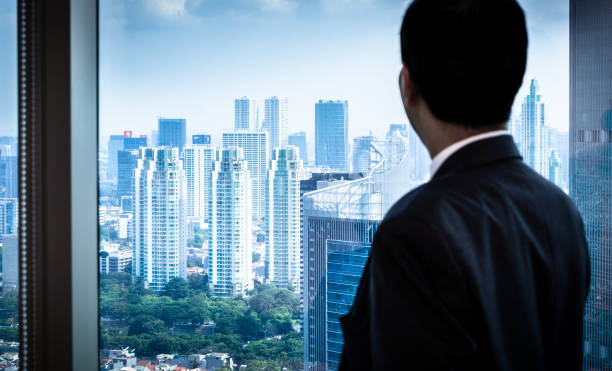 istock Business man looking to city skyline 825002498