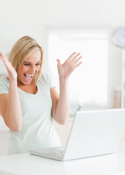 istock Laughing gorgeous woman looking at laptop 825009002