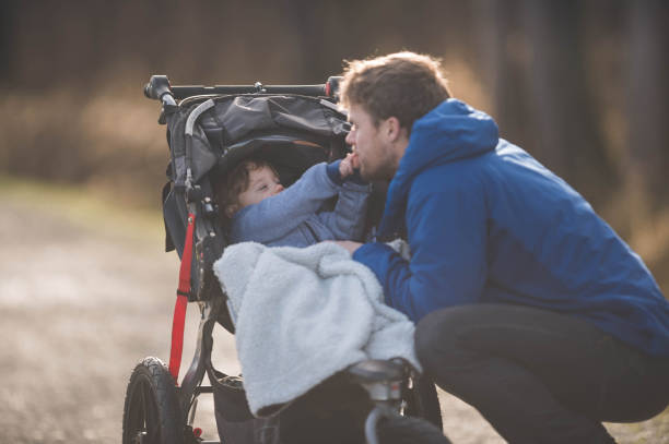 istock Dad takes baby for walk in stroller 825011886