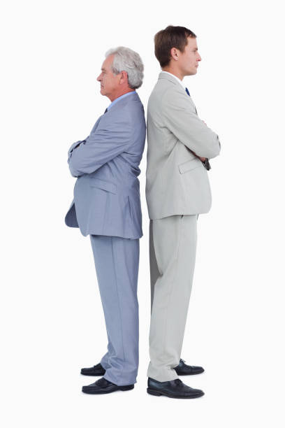 istock Side view of serious tradesmen standing back-to-back 825015574