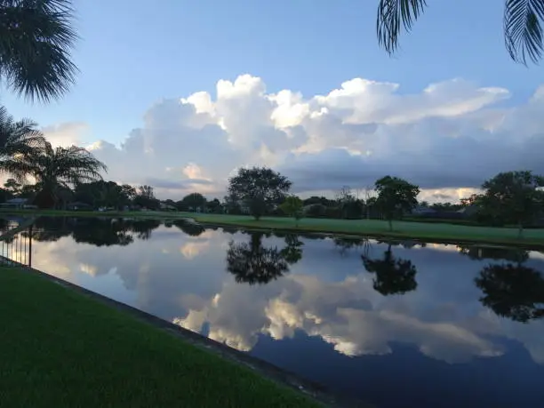 Reflections of the sunset and golf course in the lake