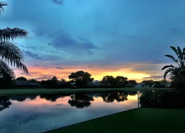 Reflections of the sunset and golf course in the lake