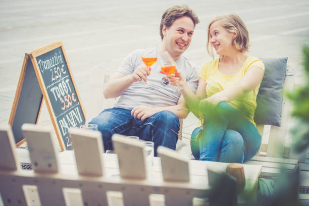 istock Couple drinking cocktail outdoors 825016390