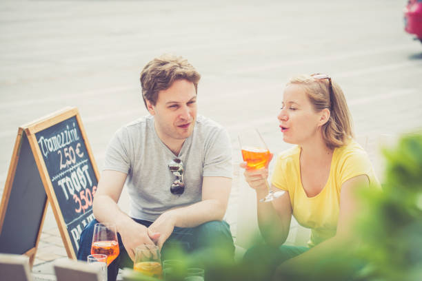 istock Couple drinking cocktail outdoors 825020180