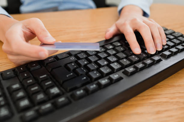 istock Woman typing on keyboard holding a credit card 825023522