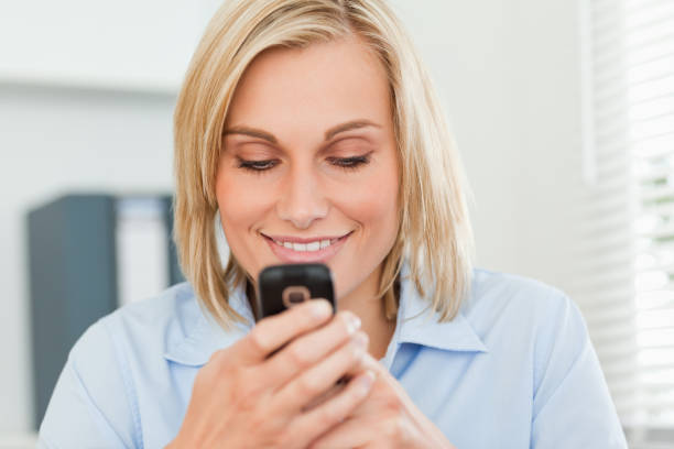 istock Smiling woman looking at her mobile 825023548