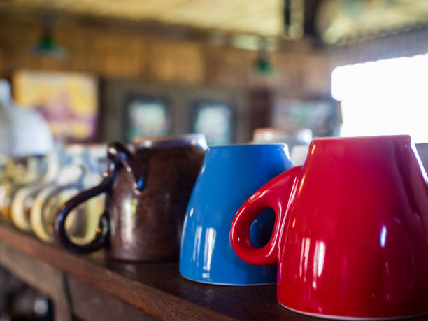 istock Cute coffee, tea cup upside down on wood shelf 825023730