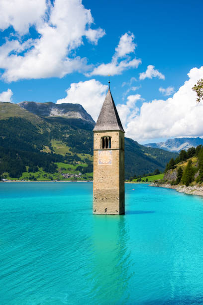 church tower of graun in the lago di resia, italy - grass church flood landscape imagens e fotografias de stock