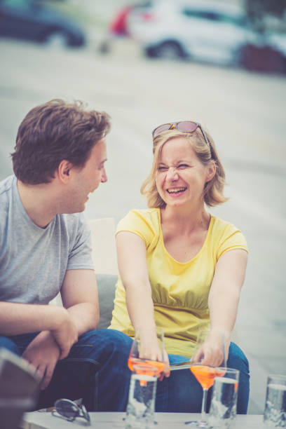 istock Couple drinking cocktail outdoors 825024052