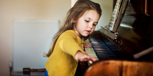 Adorable Cute Girl Playing Piano Concept