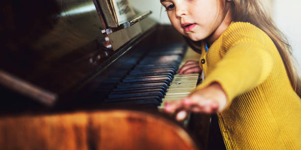 istock Adorable Cute Girl Playing Piano Concept 825024142