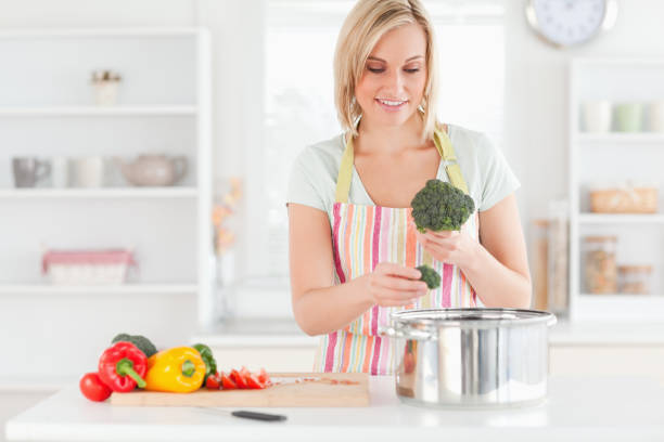 istock Woman cooking broccoli 825030456