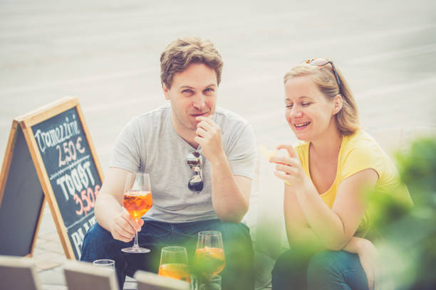 istock Couple drinking cocktail outdoors 825031344