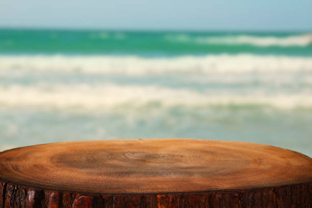 istock image of wooden table in front tropical sea background 825035008