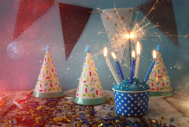 istock Birthday concept with cupcake and candles on wooden table 825035222