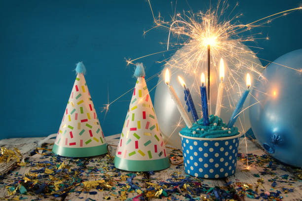 istock Birthday concept with cupcake and candles on wooden table 825035276