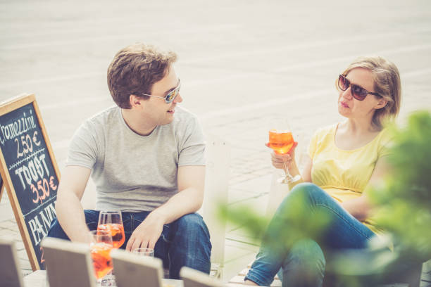 istock Couple drinking cocktail outdoors 825037538