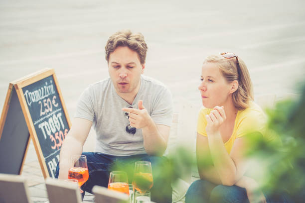 istock Couple drinking cocktail outdoors 825037800