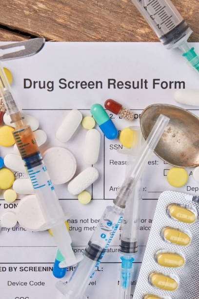 istock Drug screen result form, pills, syringes. 825045118