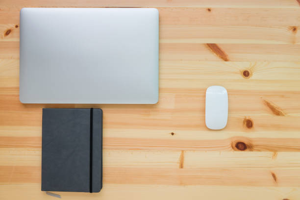 istock Business equipment concept on table top view with wooden background 825045128