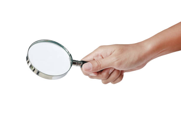 istock Hand holding Magnifying glass isolated on white. 825045318