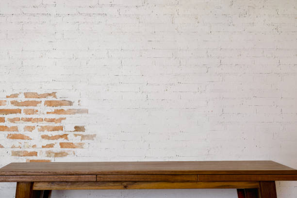 istock Mock up wooden table with white brick wall. For product display montage. 825045602