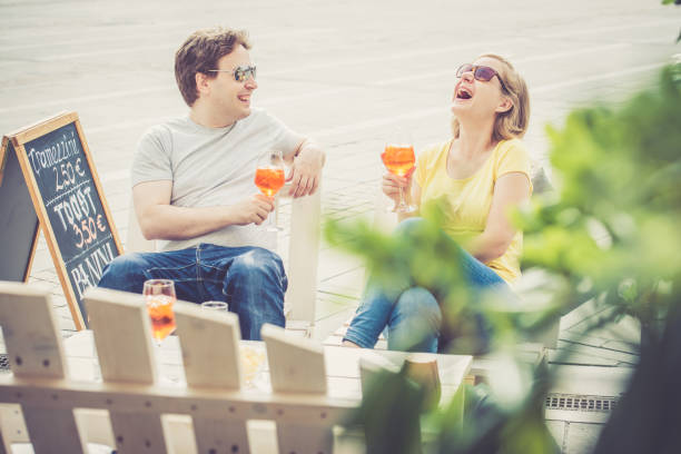istock Couple drinking cocktail outdoors 825045848