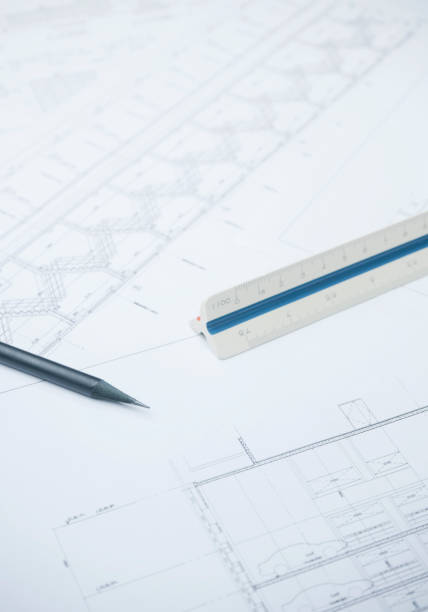 istock black pencil on architectural drawing paper and rolls for construction 825046834