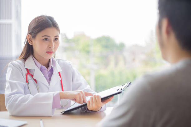 istock doctor talking with patient in hospital 825055032