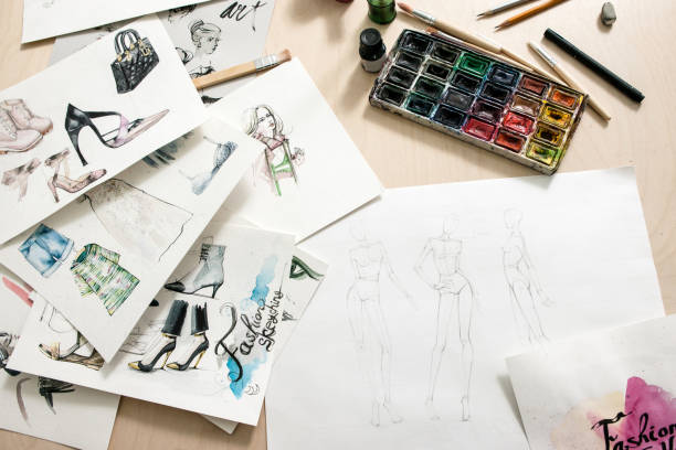 Fashion sketches on desiner desk. Art watercolor illustration of clothing creations