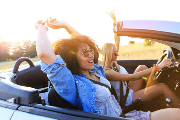 istock Girlfriends having fun on road trip 825058616