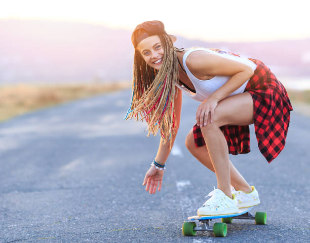 istock Smiling skater moving down on country road 825058644