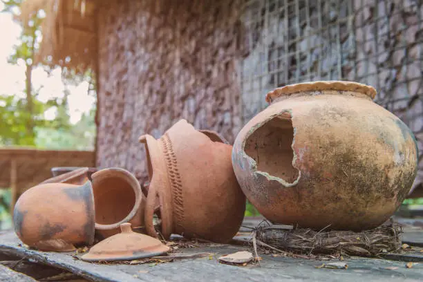Broken antique clay pot or traditional Jar on abandoned hut.