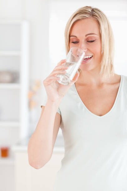 istock Smiling woman drinking water 825063762