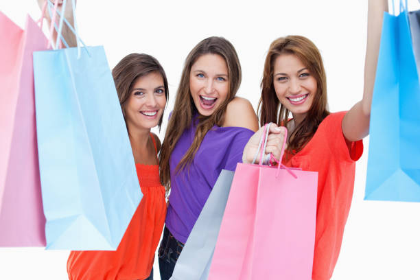 istock Three teenagers raising their arms while holding their purchases 825064402