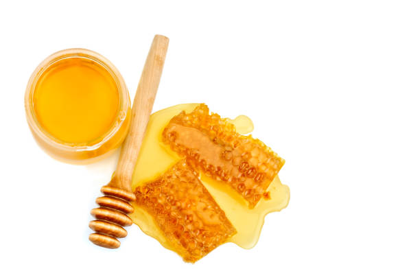istock Bank with fresh honey and honeycomb on white background 825066950