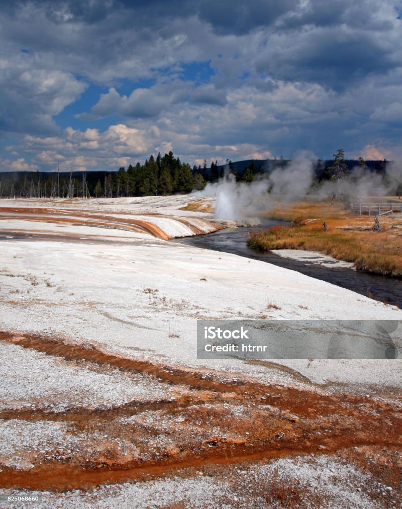 Iron Spring Creek flowing past Cliff Geyser in Black Sand Geyser Basin in Yellowstone National Park in Wyoming USA Autumn Stock Photo