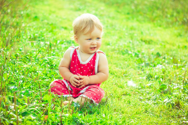 istock The child is sitting on the grass 825071524
